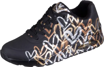 A single black sneaker with a metallic heart pattern.