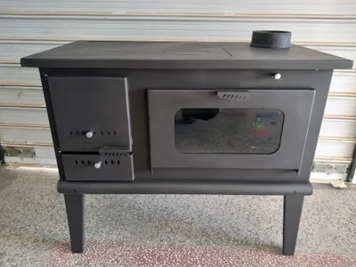 A black wood-burning stove with a glass window is shown from the front.