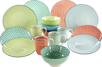 A collection of dinnerware items, including plates, bowls, and mugs, arranged on a white background.