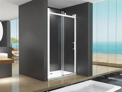 A modern bathroom with a shower enclosure overlooking a beach scene.