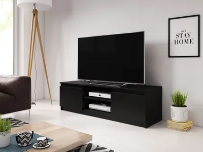 A modern living room with a black TV stand, a large television, a brown leather sofa, and a floor lamp.