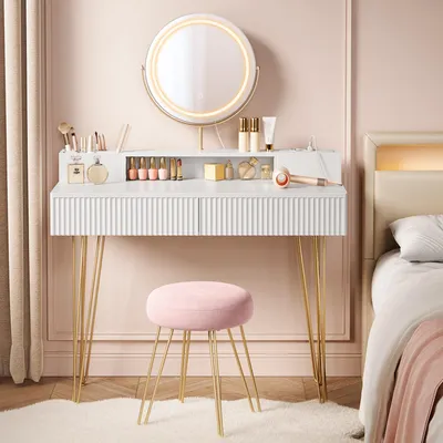 A vanity table with a mirror and stool in a bedroom setting.