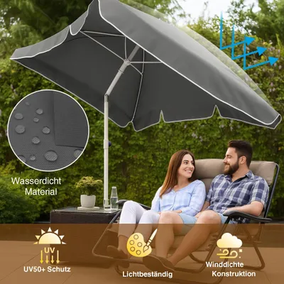 A couple relaxing under a large gray garden umbrella on a patio.