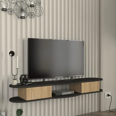 A wall-mounted TV stand with a television on it, against a ribbed wall.