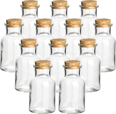 A collection of small glass jars with cork stoppers, arranged in rows on a white background.