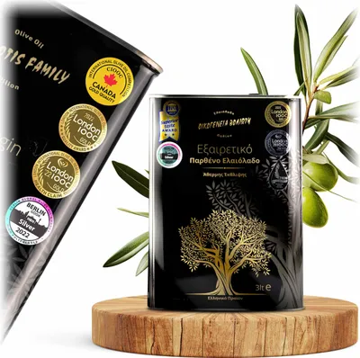 A black olive oil tin with gold accents and awards displayed on a wooden stand, with an olive branch in the background.