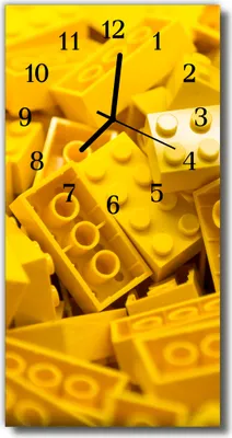 A close-up shot of yellow building blocks arranged to form a clock face.