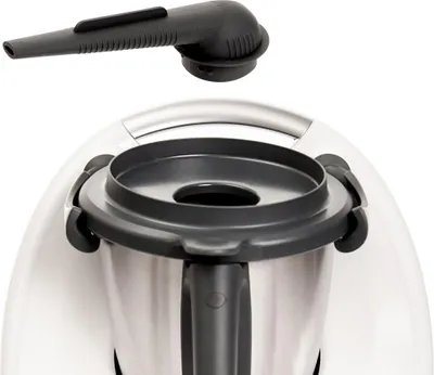A close-up view of a kitchen appliance accessory, specifically a steam diverter, positioned above the appliance's main unit.