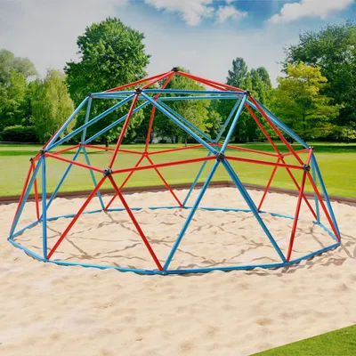 A geodesic dome climber in a park setting with sand on the ground and trees in the background.