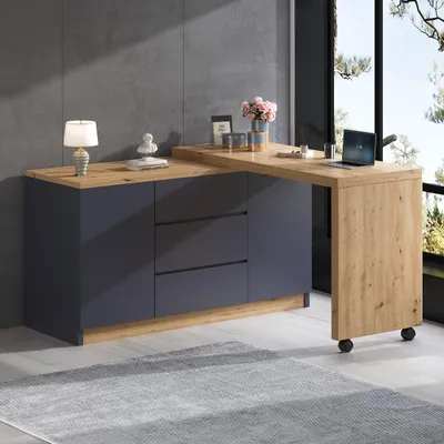 A modern L-shaped desk and sideboard combination with a laptop and decorative items on top, set against a grey wall and large window.