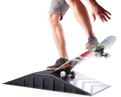 A person is using a skateboard on a mini ramp.