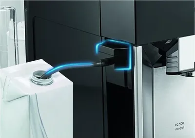 A close-up of a coffee machine being connected to a milk carton via a hose, with a blue glow highlighting the connection point.