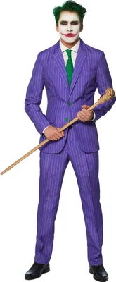 A person dressed as the Joker, holding a cane, stands against a white background.