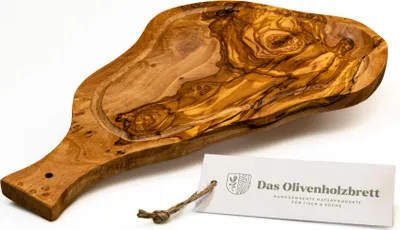 A wooden cutting board with a handle and a carved-out section, placed on a white background with a tag attached.