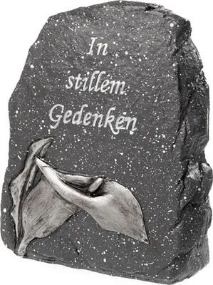 A stone plaque with engraved text and a floral design.