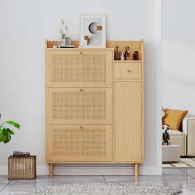 A wooden shoe cabinet with rattan detailing is shown in a room setting.