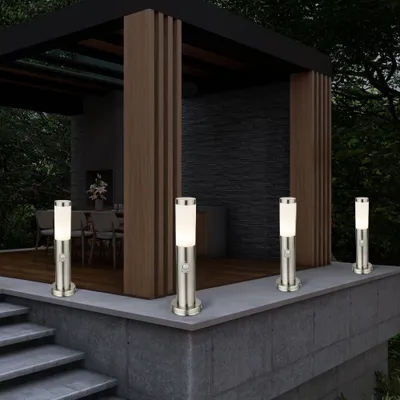Outdoor patio area with a modern gazebo and four bollard lights.