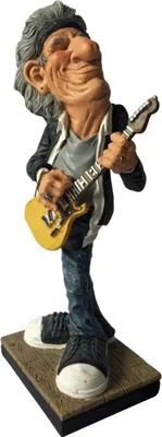 A figurine of a rockstar playing an electric guitar.