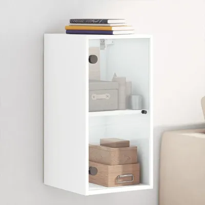 A white wall-mounted cabinet with glass doors, filled with storage boxes and books.