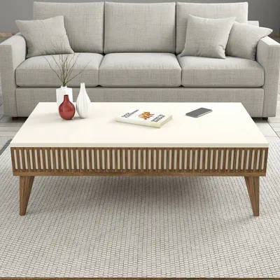 A coffee table in a living room setting with a couch in the background.