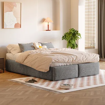 A bedroom scene with a bed, rug, and artwork.