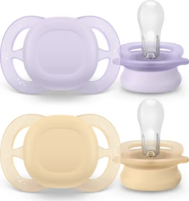 Two pairs of baby pacifiers, one purple and one beige, displayed against a white background.