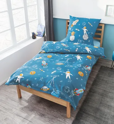 A child's bed with space-themed bedding.