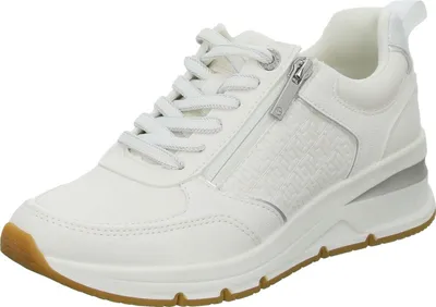 A white sneaker with silver accents and a brown sole is shown against a white background.