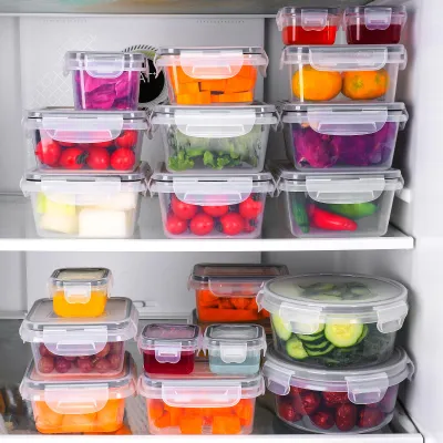 A refrigerator shelf filled with various sizes of clear plastic food storage containers filled with colorful fruits and vegetables.