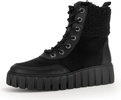 A black lace-up boot with a thick sole and faux fur lining.