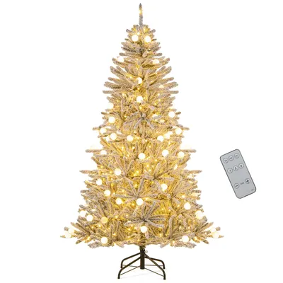 A decorated artificial Christmas tree with lights and a remote control.