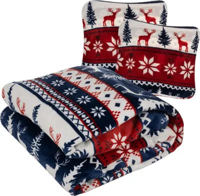 A folded blanket and two pillowcases with a Christmas-themed pattern.