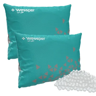 Two teal-colored dehumidifier bags with a geometric pattern and a pile of white beads.