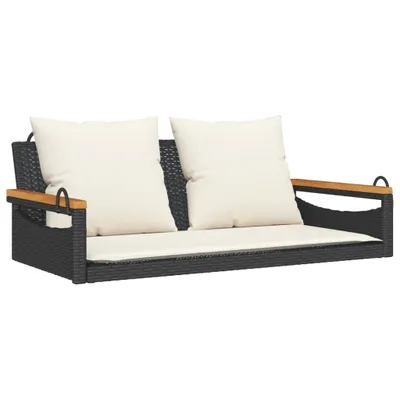 A product shot of a black rattan hanging bench with cream cushions, isolated on a white background.