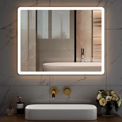 A modern bathroom vanity with a large illuminated mirror above a sink and faucets.