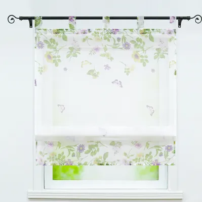 A floral patterned sheer Roman blind is shown hanging on a window.