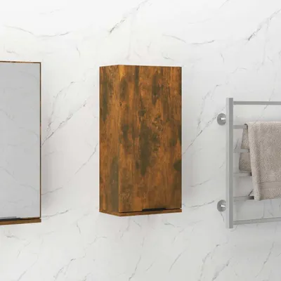 A wooden cabinet mounted on a marble-patterned wall next to a towel rack.