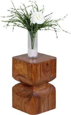 A wooden side table with a vase of flowers on top.