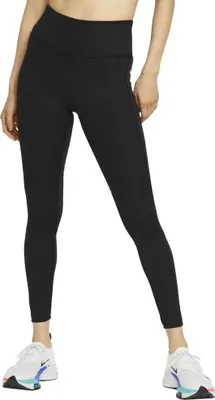 A person wearing black leggings and white sneakers, standing against a white background.