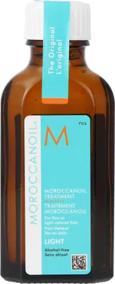 A close-up shot of a Moroccanoil Treatment Light bottle.