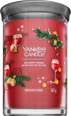 A Yankee Candle Holiday Cheer tumbler candle with festive Christmas decorations.