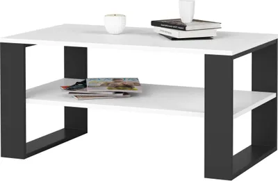 A modern coffee table with a white top and black frame.