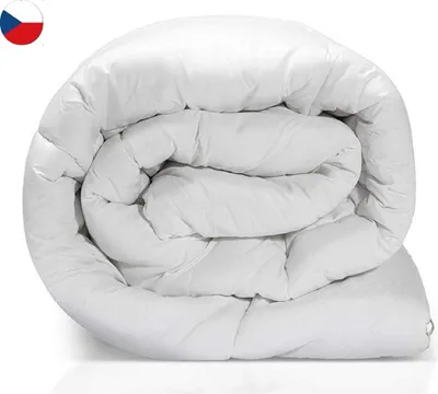 A white duvet rolled up on a white background.