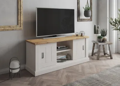 A TV stand with a TV on top, in a living room setting with plants and decor.