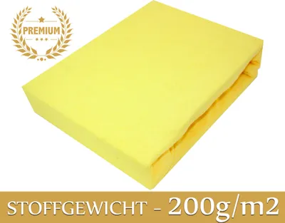 A folded yellow fitted sheet on a white background.