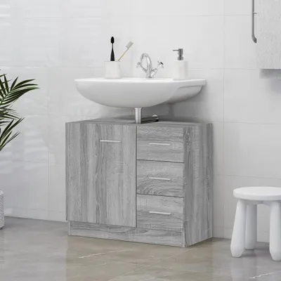 A bathroom vanity with a sink and cabinet, along with a small stool and a plant.