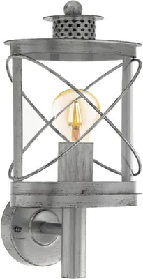 A silver-antique outdoor wall lamp with a clear glass enclosure and a visible light bulb.