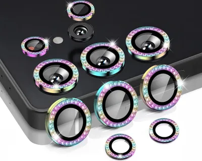 A collection of camera lens protectors with colorful, gem-like borders, arranged on a dark surface and a white surface.