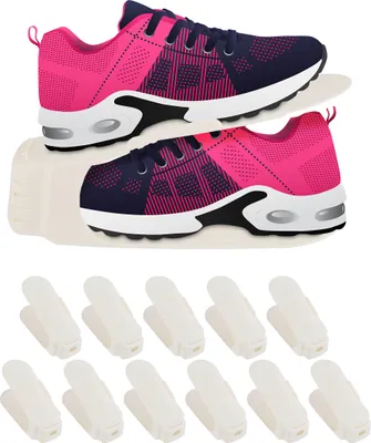 A pair of pink and navy blue athletic shoes is displayed on a shoe rack, with a set of white shoe clips arranged below.