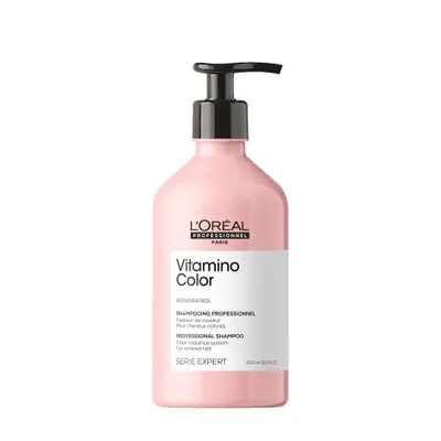 A pink bottle of L'Oréal Professionnel shampoo with a black pump dispenser, set against a plain white background.
